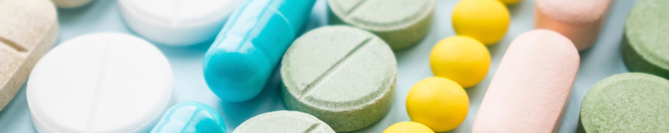 Pill variety Divers shaped colorful pills lined up and lying next to each other.