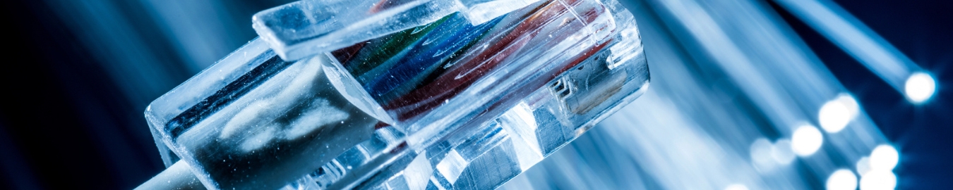 Fibers Network cable and optical fibers with lights in the background.